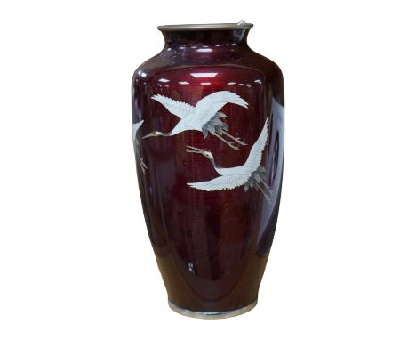 A mid 20th century Japanese cloisonné enamel red ginbari ground vase, decorated with cranes, 21cm high. Condition - fair to g