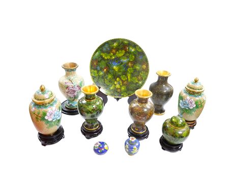 A collection of Chinese cloisonné enamel wares, with mixed coloured backgrounds, all with floral designs, some with stands, p