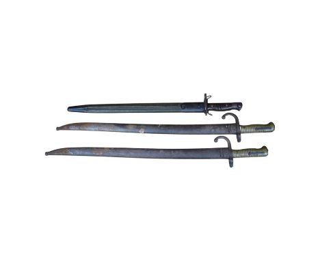 Two 19th century French bayonets and an American example, largest 71cm. Condition - fair Press studs functioning, some typica