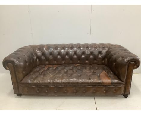 An early 20th century buttoned brown leather Chesterfield sofa, width 200cm, depth 90cm, height 72cm. Condition - fair, some 