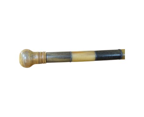 An African two colour banded horn walking stick with turned handle, 87cm in length. Condition - fair, bowed