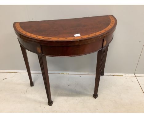 An Edwardian inlaid mahogany demi lune card table, width 91cm, height 73cm. Condition - top scratched, otherwise fair