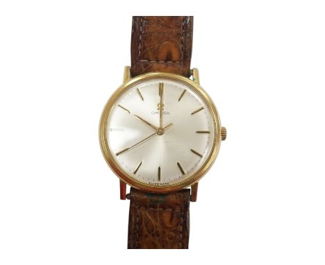 A gentleman's gold plated Omega manual wind wrist watch, on a leather strap, case diameter 34mm. Condition - Fair The watch t