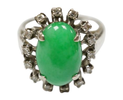 A white metal, jade and diamond set oval cluster ring, size N, gross weight 5.4 grams. Condition - fair to good