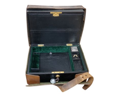 Wells &amp; Lambert, London, a travelling writing box and outer leather case, with Bramah lock and keys, with monograms and i