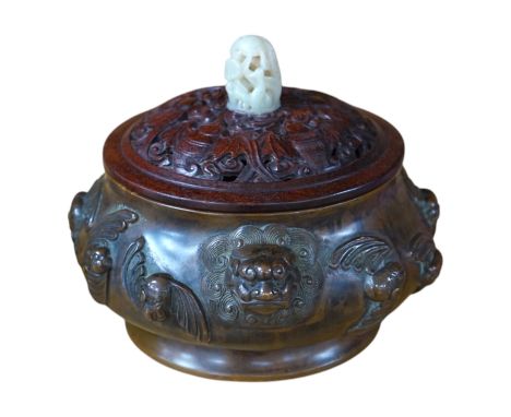 A Chinese bronze censer, with carved wooden cover and jade finial, 17cm high. Condition - good