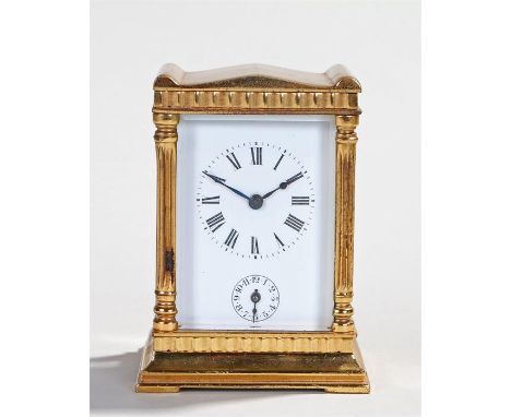Miniature gilt metal carriage clock, the shaped top above a white enamel dial with Roman hours and subsidiary dial, lever pla