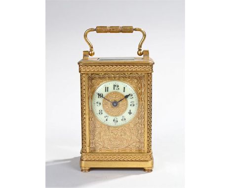 Early 20th Century gilt brass carriage clock, the five glazed case with a cream enamel chapter ring with Arabic hours, swag d