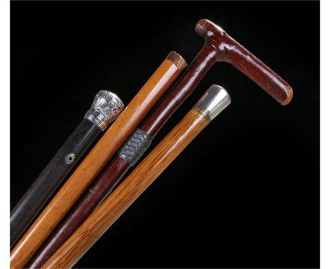 Four walking sticks to include a branch stick with woven white metal band, an ebony example, a gold top example and silver to