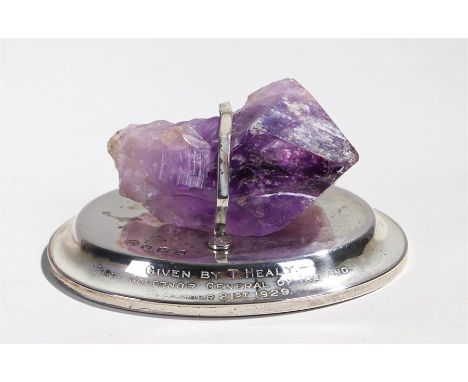 Of Irish interest, a silver and amethyst mounted desk weight, the piece of amethyst at 8cm wide with a silver band holding it