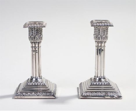 Pair of Victorian silver candlesticks, 1896 and 1897, maker JR WD, the cluster column and leaf top above a step weighted base