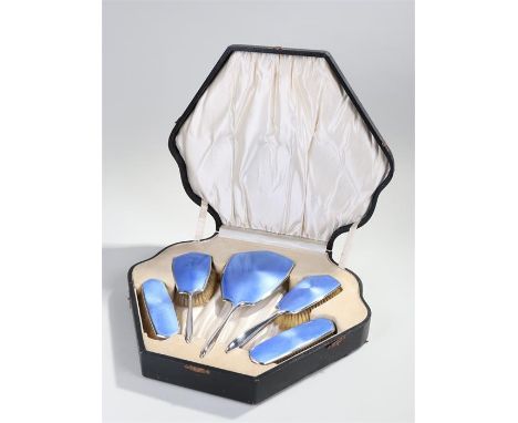 George V cased silver and guilloche enamel vanity set, Birmingham 1926,  with a mirror and four brushes with blue enamel back