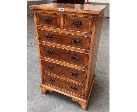 A small yew veneered chest of recent manufacture, with two short over four long graduated drawers raised on bracket feet. 18¾