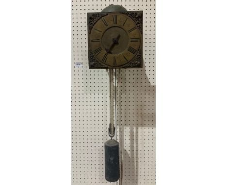 An early 18th century hook and spike wall clock, the 8' square brass dial with Roman chapter, stylised fleur-de-lys half hour