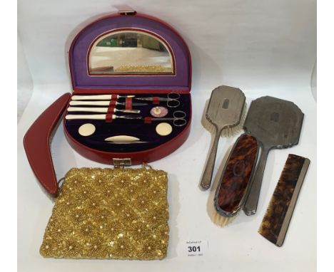 A leather cased manicure set; a leather backed clothes brush; an evening bag; a silver hand mirror and brush, a silver backed