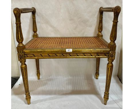 A 19th century French giltwood stool with caned seat, on fluted tapered legs. 24½' wide