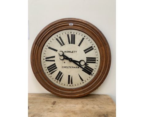 An oak dial clock, the enamel dial with Roman numerals signed Howlett, Cheltenham. Electric movement. c.1940-50. 32½' diam.