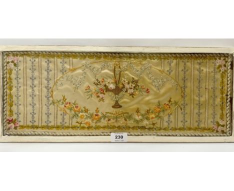A Regency silk panel, worked with a basket of flowers in a gold thread bordered reserve. 7½' x 20½'