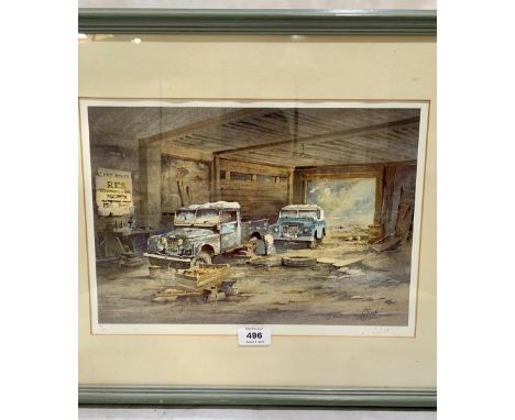 A framed print after G. Tilbrook. Two Land Rovers in a barn. Signed in pencil and numbered 449/850. 10' x 14'