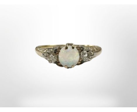 An antique yellow gold opal and two stone diamond ring, size S. CONDITION REPORT: 3.3g. The shank marks are rubbed.