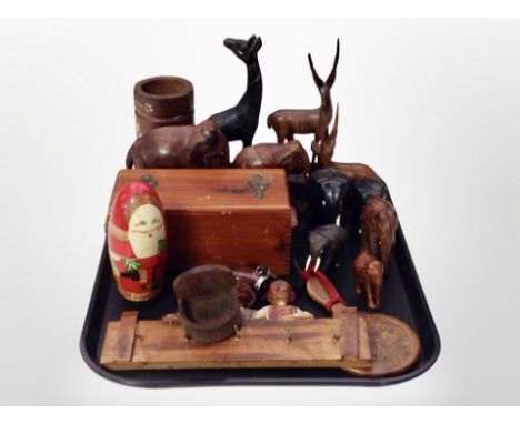 A group of carved hardwood elephant ornaments, antelope ornaments, further giraffe figure, Russian doll depicting Santa Claus