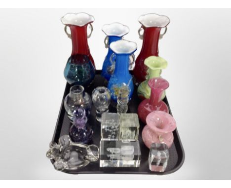 Two pairs of coloured glass twin handled vases, clear glass paperweights, Caithness bottle with stopper, Mdina swirl vase 