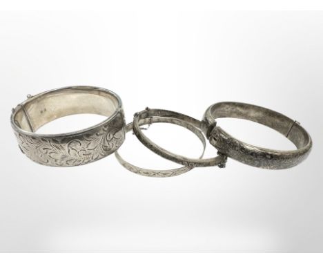 A good quality engraved silver bangle, London 1963, together with three further silver bangles. (4) CONDITION REPORT: 92.4g.