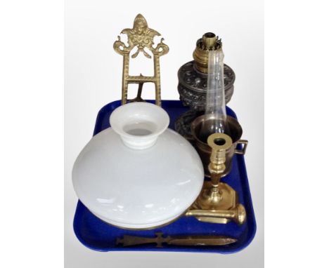A cast metal oil lamp base, opaque glass shade, brass easel, pestle and mortar, candlestick and letter knife 