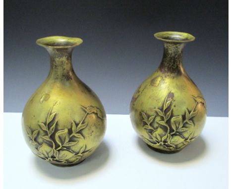 A pair of gold splashed polished bronze vases, each cast in relief on one side with a bat flying towards peaches, the other w