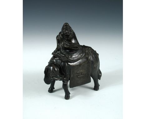 A 19th century bronze elephant and rider censer, the caparissoned pachyderm standing with its small head turned to one side, 