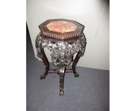 A 19th century marble inset hardwood stand, the octagonal top with beading above the pierced and carved fruiting vine apron, 