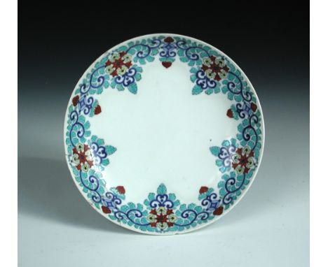 An Arita plate in Nabeshima taste, possibly 18th century, painted with a cinquefoil flower and foliage rim band in turquoise,