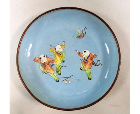 A Canton turquoise enamel dish painted with three children playing with a butterfly kite, four character mark of Qianlong in 