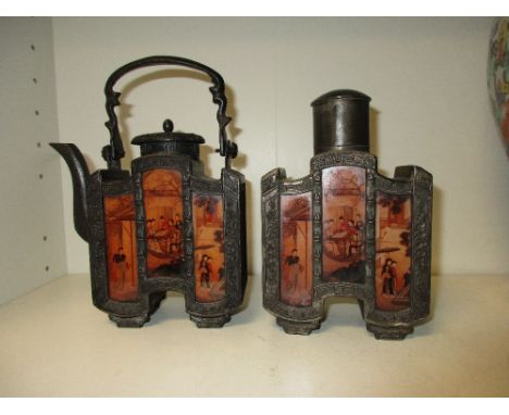 A 20th century decorated reverse glass and pewter tea caddy, tea pot and covers, the glass panels with scenes of figures, the