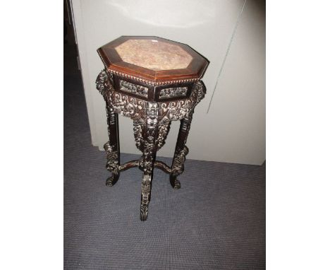 A 19th century marble inset hardwood stand, the octagonal top with beaded edge, the apron pierced and carved with fruiting vi