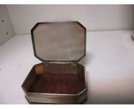 A 19th century engraved mother of pearl snuff box, the canted rectangular lid engraved with flowers and foliage within diamon