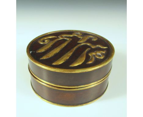 A parcel gilt bronze box and cover, the circular top with gilt Arabic inscription and rim, a three character commendation mar
