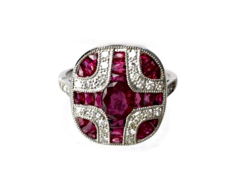 RUBY AND DIAMOND RING, the central oval ruby flanked by calibre cut rubies and round brilliant cut diamonds, the diamonds tot