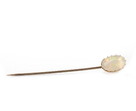 LATE VICTORIAN OPAL PIN, mounted with an oval cabochon opal 15mm long, to a pin 64mm long, unmarked