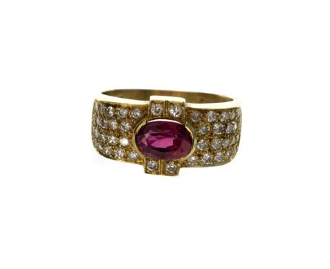 RUBY AND DIAMOND RING, set with a single oval faceted ruby to a broad bezel grain set with diamonds, in eighteen carat gold, 