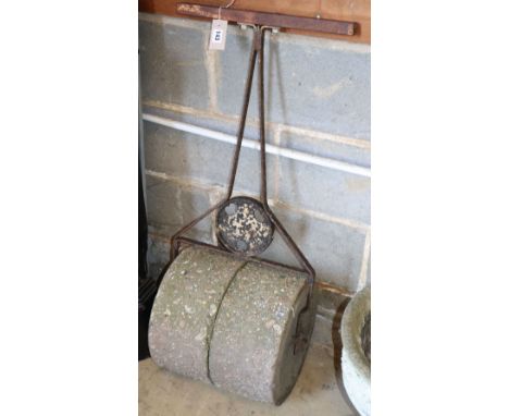 A wrought iron and concrete garden roller, W.40cm D.36cm H.100cm