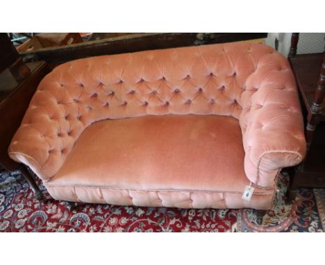 A small antique pink button back upholstered settee, width 140cm, depth 64cm, height 69cm