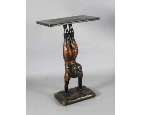 A 20th century carved and painted wood occasional table, with faux marble top, blackamoor acrobat stem and cushion support, W