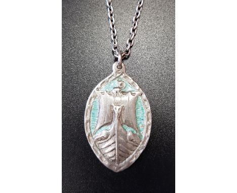 ALEXANDER RITCHIE IONA SCOTTISH SILVER AND ENAMELLED PENDANT of elliptical form, depicting a ship, with turquoise coloured en