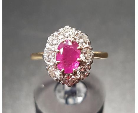 IMPRESSIVE RUBY AND DIAMOND CLUSTER RINGthe central oval cut ruby approximately 0.75cts in eight diamond surround totalling a