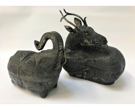 TWO INDIAN BEETLE NUT BOXESin white metal, one depicting a recumbent deer, 17cm long; the other an elephant with its trunk ra