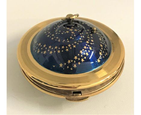 1950s KIGU 'FLYING SAUCER' MUSICAL COMPACT With brass frame and central blue enamel and gilt star decoration, 7.5cm diameter 