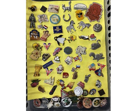 Enamel pin badges on yellow sheet including Noddy and Coca-Cola 