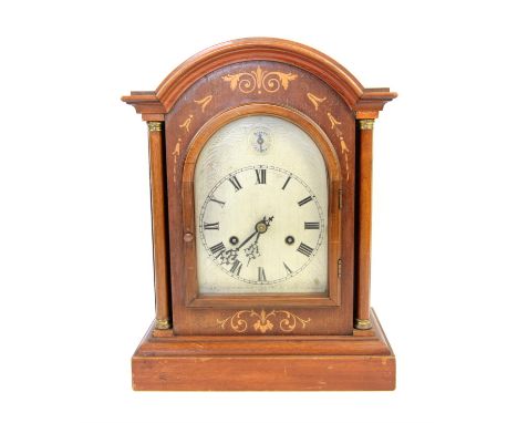 Early 20th century walnut and marquetry inlaid mantle clock of architectural form, chiming on gongs, silvered dial with Roman