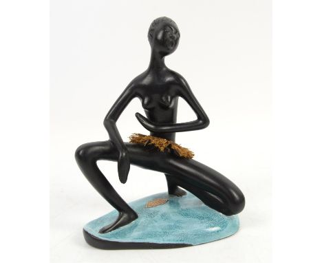 Viennese Leopold Anzengruber ceramic figure of an African woman kneeling in a dance pose with fibre skirt, c.1950s,  on turqu